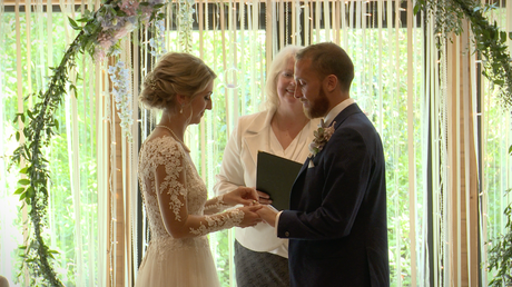 the bride puts the grooms wedding ring on at their ceremony Styal Lodge in Cheshire caught on video by love gets sweeter