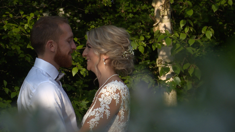 golden hour light shimmers on the brides face as they pose for their wedding photos at Styal Lodge in Cheshire
