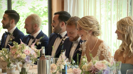 the top table laugh as the father of the bride delivers his speech