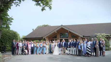 a large group photos outside Styal Lodge in Cheshire of all the wedding party