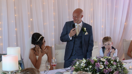 the bride laughs as she wipes away her tears during the grooms speech at the blue mallard