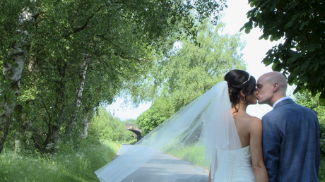 a bride and groom kiss on a country lane in Burscough and Lathom