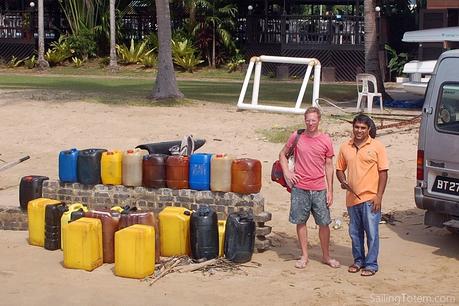 jerry cans of fuel on a beach
