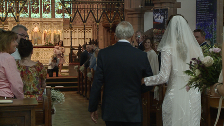 a grandad walks his granddaughter the bride down the aisle at St Peters church in woolton