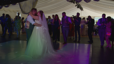 the bride and groom enjoy their first dance reveal at the lakeside marquee at thornton manor