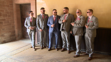 the groom and groomsman strike a cool pose for their wedding photographer in their sunglasses at thornton manor