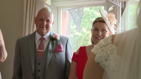 dad fights back the tears as Mum smiles at their daughter now a bride ready to get married