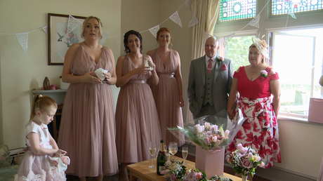 the bridesmaids , father of the bride and Mum wait eagerly for the bride to do her reveal at thornton manor