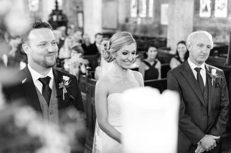 Bride smiles during ceremony at church
