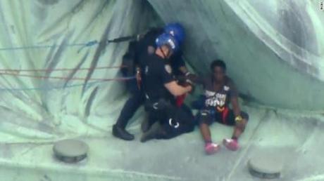 Woman protesting on 4th of July climbs the Statue of Liberty