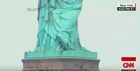 Woman protesting on 4th of July climbs the Statue of Liberty