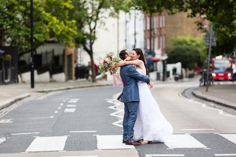 St Stephens Hampstead Heath Wedding Venue couple embrace outisde on zebra crossing