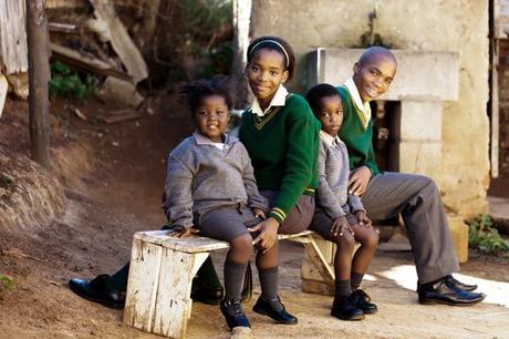 This family of school kids waiting for the bus to their way to school, Africa