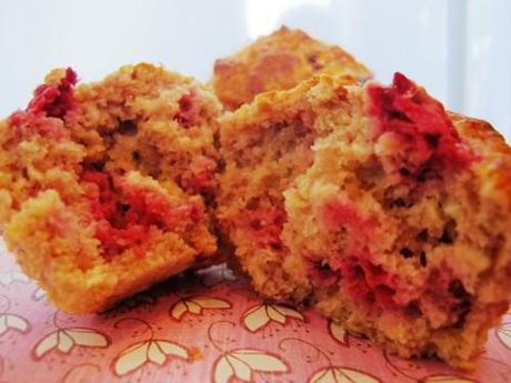 A raspberry oatmeal low fat muffin ripped in half showing the inside