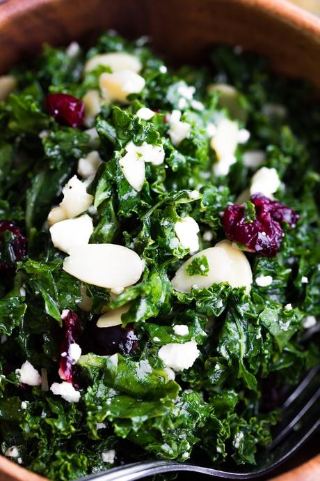 close up shot of the staple kale salad recipe with feta, almonds and cranberries