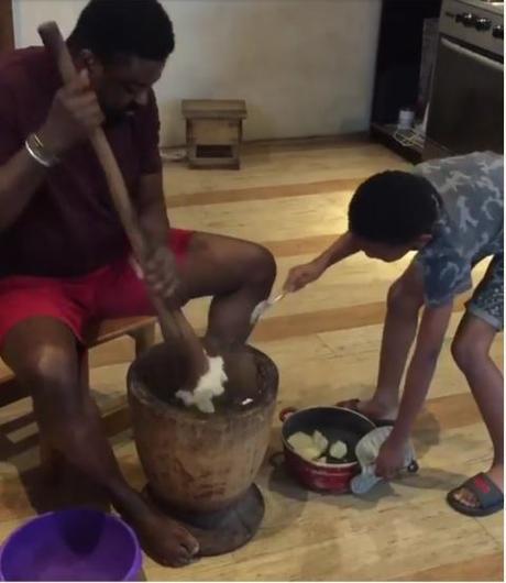 Nollywood Filmmaker, Kunle Afolayan Teaches His Son How To Pound Yam (Video)