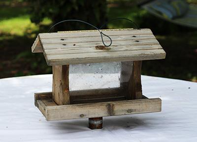 weathered wood bird feeder and stand