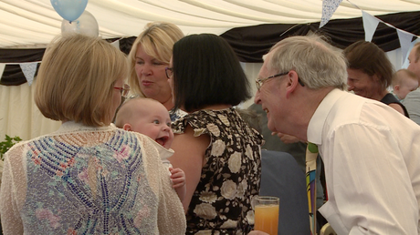 grandad gets the biggest laugh off his grandson at a christening party  at a christeing party at Alder Root Golf Club in Warrington with a family videographer capturing the natural moments