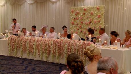 the groom buries his head in his hands as the best men embarrass him during the wedding speeches for the wedding video in the wirral