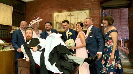 the priest at st saviours church in the wirral photo bombs the formal signing of the register shot by diving on the table for the photo and video