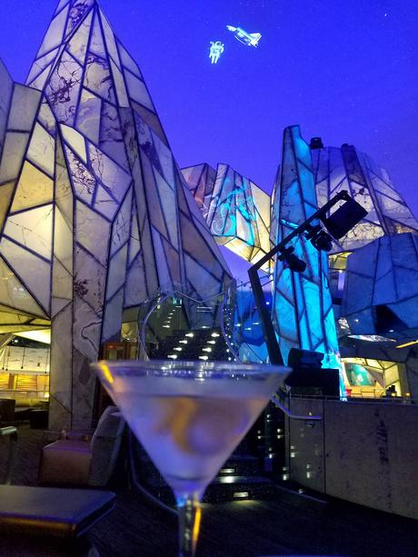 Martini in foreground, Vista Lounge in background, Space Shuttle and astronaut projected on dome