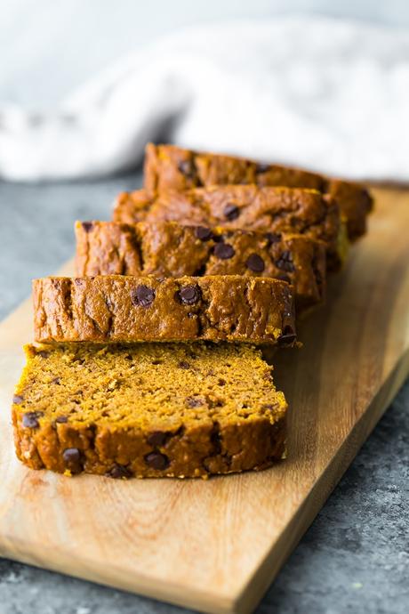 healthy pumpkin bread recipe sliced and laying on a cutting board.
