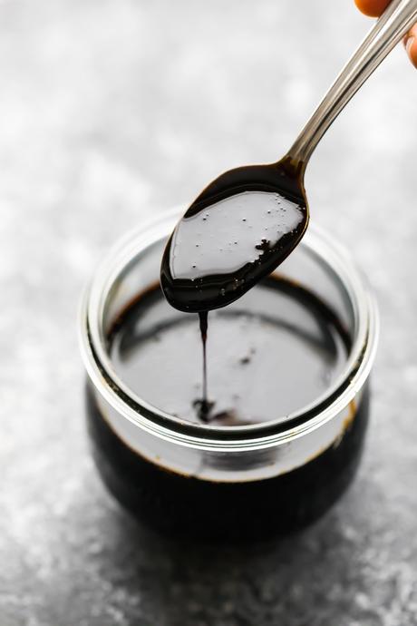 spooning the balsamic reduction into a jar