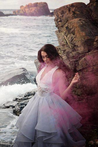 beach styled shoot among the rocks shrouded in pink smoke alexi
