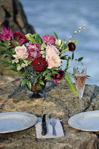 beach styled shoot wedding place settings on rocks with floer centerpiece alexi