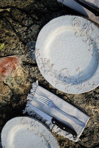 beach styled shoot wedding place settings on rocks with white dishes alexi