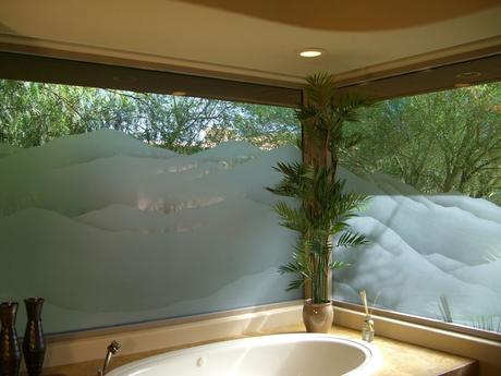 two windows with custom mountain frosted glass and natural light