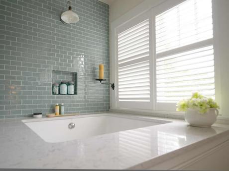 custom plantation style shutters next to bathtub natural light