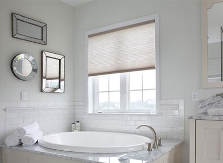 bathroom shades half open natural light near bathtub