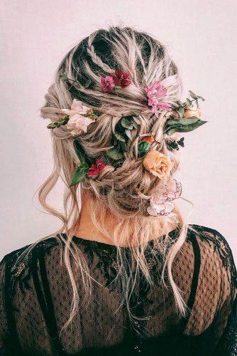 wedding hairstyles 2019 messy updo on blonde hair with bright flowers cruzmakeup