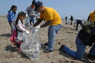 Image: Sailors clean a beach, by Official U.S. Navy Page on Flickr