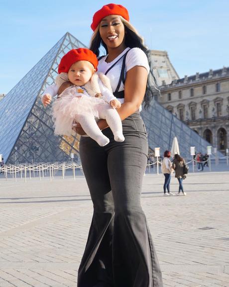 Victoria Kimani poses with a baby in Paris