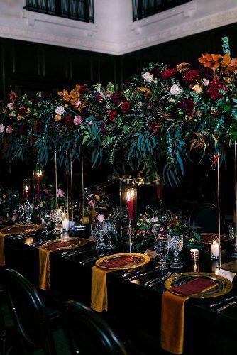 wedding trends 2019 dark mood bridal table fall colors tall orange burgundy greenery flower centerpieces candles camrynclairphoto