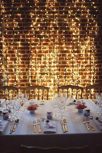 wedding trends 2019 bridal light bulbs arrangement on brick loft wall elegant reception with red roses cathy dudzinski photography