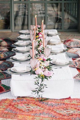 wedding trends 2019 low boho table pillows around eclectic pink glasses candles flowers and greenery ugophotography