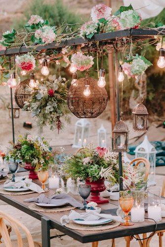 wedding trends 2019 hanging flower decor and light bulbs above the eclectic table nikosmylonasgr