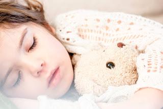 Image: Sleeping with her brown plush bear, by Snapwire on Pexels