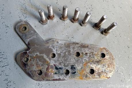 Chainplate removed and placed on a table and surrounded with bolts, all showing signs of surface rust
