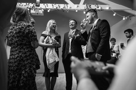 the groom jokes with guests