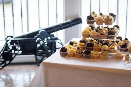 the wedding cake with a cannon in the background