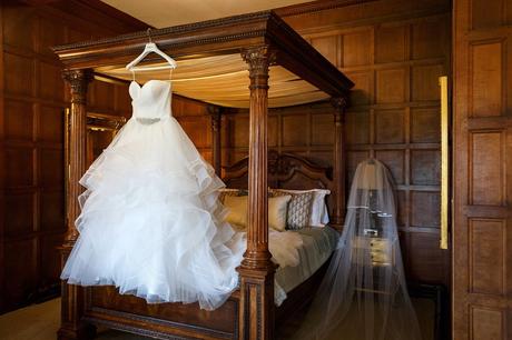 Hengrave Hall Wedding Photography | Alice and Nick the brides dress hanging in the girls room