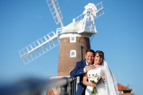 bride and groom in front of cley windmill