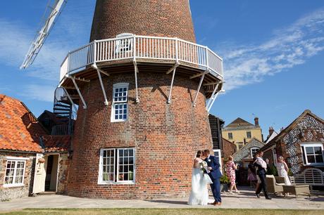 kisses outside a cley windmill wedding