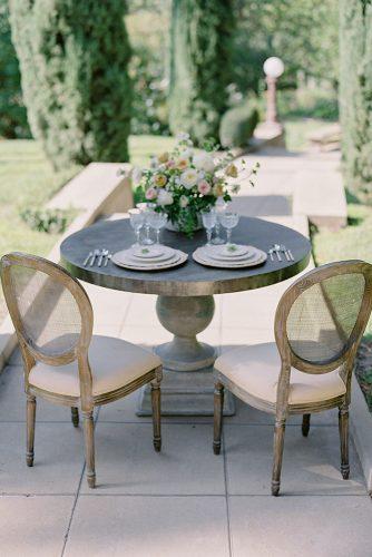 besame wedding styled shoot round small outdoor table with beige plates carrie and flower roses centerpiece besame events carrie king photographer
