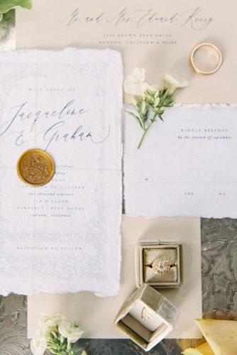 besame wedding styled shoot wedding calligraphic invitations and rings in a beige box carrie king photographer