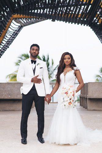 real wedding photography cindy glen photo outdoor bride with loose curls in lace dress with cascading orchid groom in white black suit stanlo photography